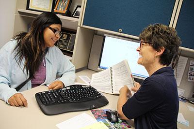 Advisor talking with SJC student providing academic support to help the student achieve their education and career goals.